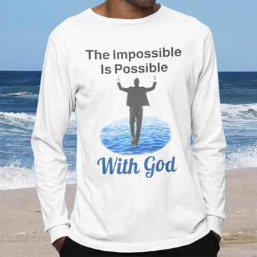 Long-sleeve Bella+Canvas t-shirt made from preshrunk ring-spun cotton with “Impossible Man” design message, “The Impossible Is Possible with God,” inspirational apparel calling believers to step out in faith and trust God for more than they can ask or imagine, man wearing white long-sleeve t-shirt